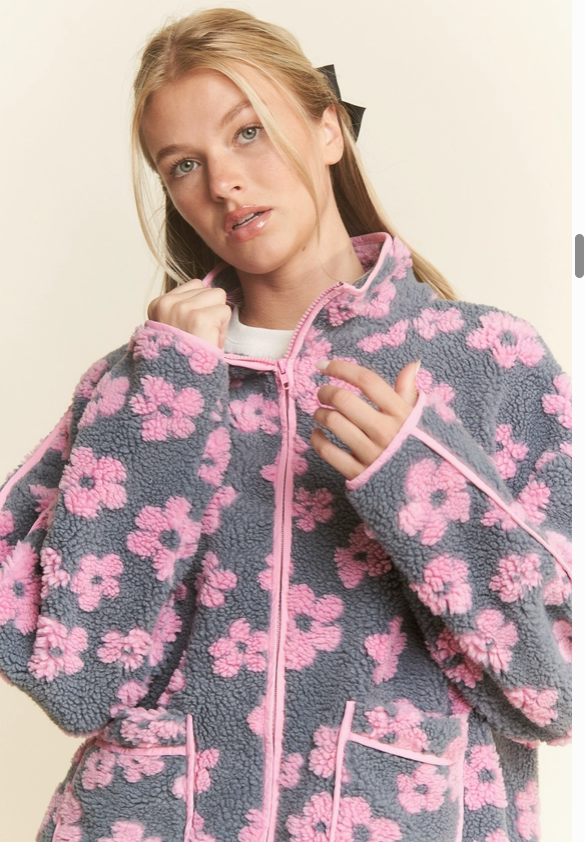 Close-up of daisy pattern and sherpa texture on oversized jacket