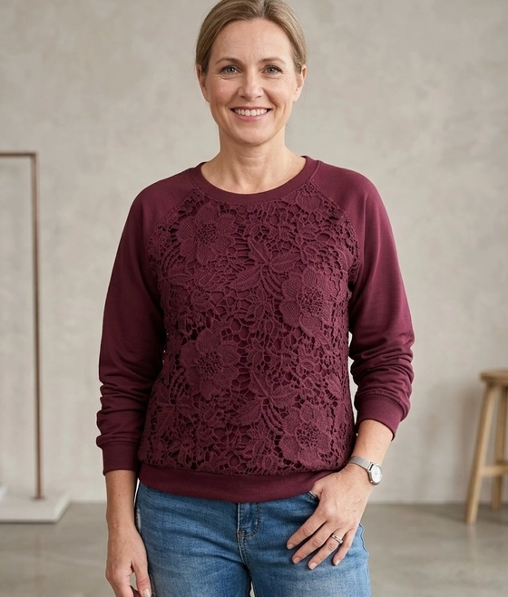 Close-up of floral lace patch detail on French Terry pullover