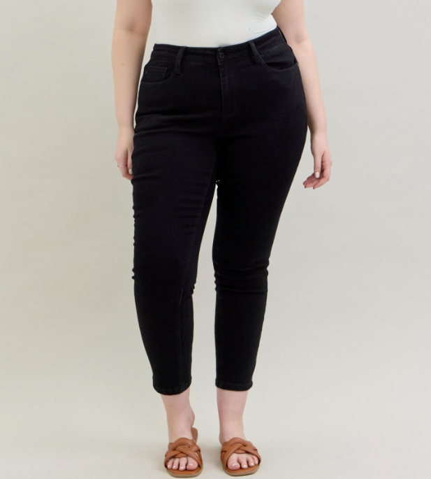 Judy Blue black slim fit mid-rise jeans on a plus-size model, front view