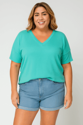 Front view of a mid-size woman wearing a seafoam knit short sleeve top with a relaxed fit and soft drape, styled for a casual yet polished look.