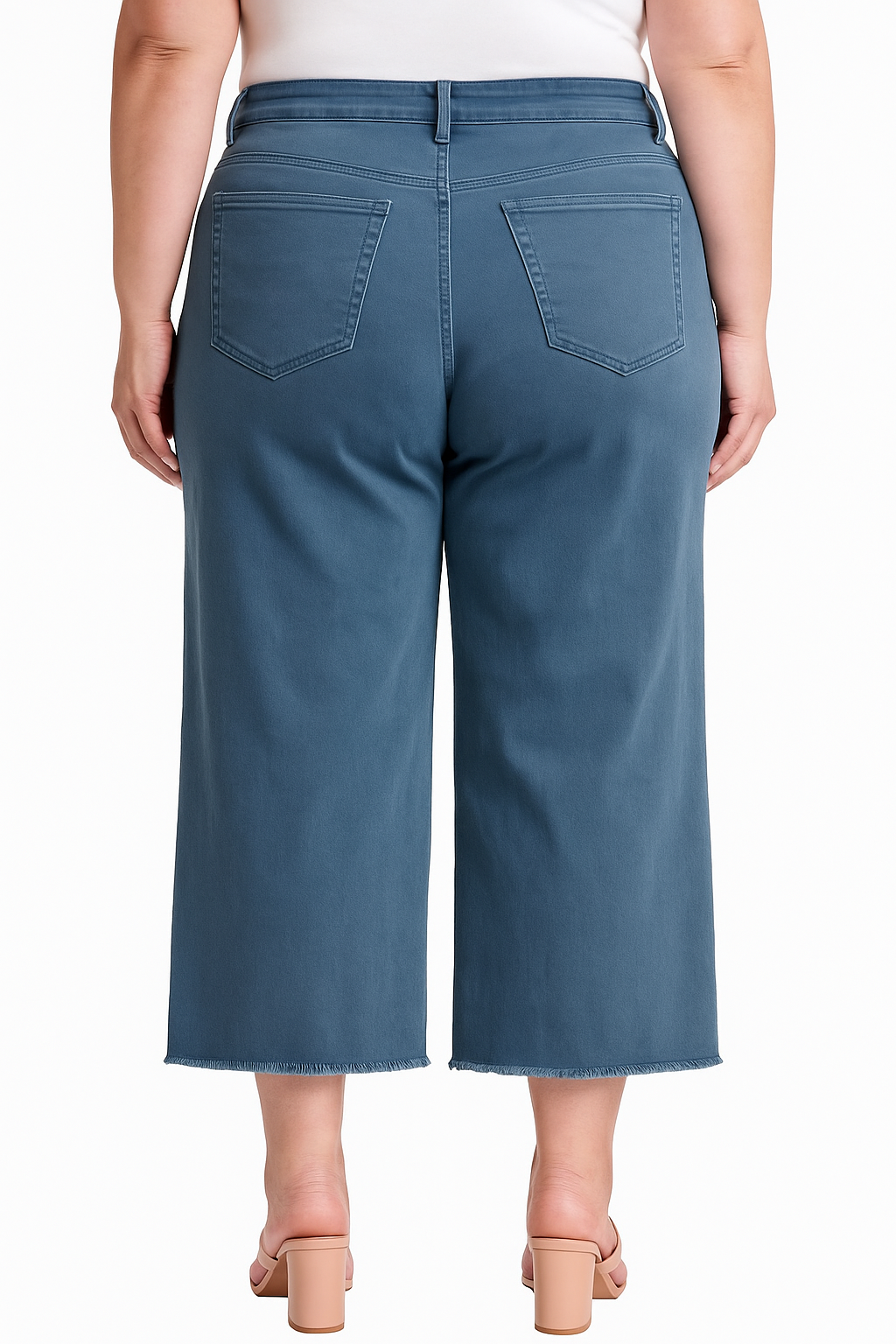 Back view of plus-size model in Chloe tummy tuck cropped jeans in slate blue with fray hem and high-waisted fit