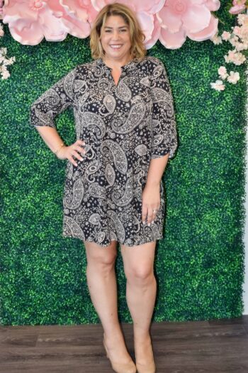 Woman wearing the Vanessa plus size black and tan paisley shirt dress with roll-tab sleeves and ankle boots