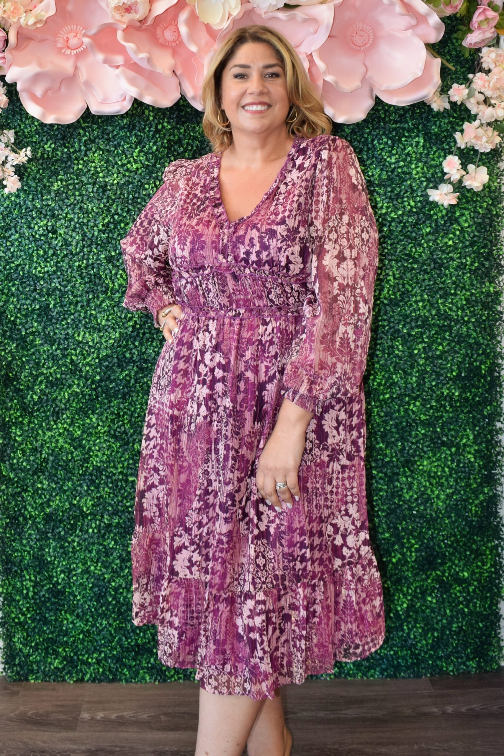 Woman wearing the Evangeline plum chiffon lurex midi dress with long sleeves and V-neckline, perfect for weddings or holiday parties