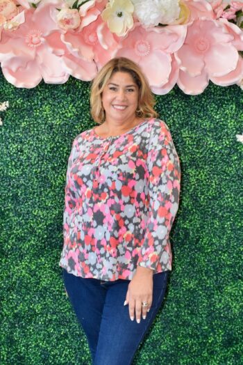 Plus size woman wearing Dear Scarlett floral henley hacci top in vibrant pink, coral, berry, and gray print – soft, wrinkle-free knit.