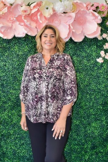 Dear Scarlett Savannah Lizzy Top in snakeskin print featuring a split neckline, lightweight wrinkle-free fabric, and 3/4 roll-tab sleeves, styled on a plus-size model