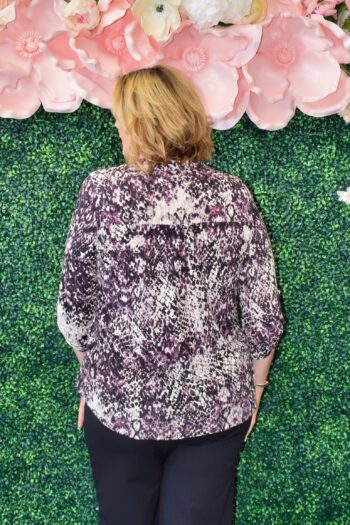 Back view of Dear Scarlett Savannah Lizzy Top in snakeskin print showing lightweight wrinkle-resistant drape and flowy fit, available in plus and missy sizes.