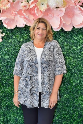 Front view of a plus-size model wearing the Dear Scarlett Plus Size Paisley Open-Front Kimono Cardigan. Features a lightweight, wrinkle-free fabric, half sleeves, and a versatile open-front design perfect for layering over casual or office looks.