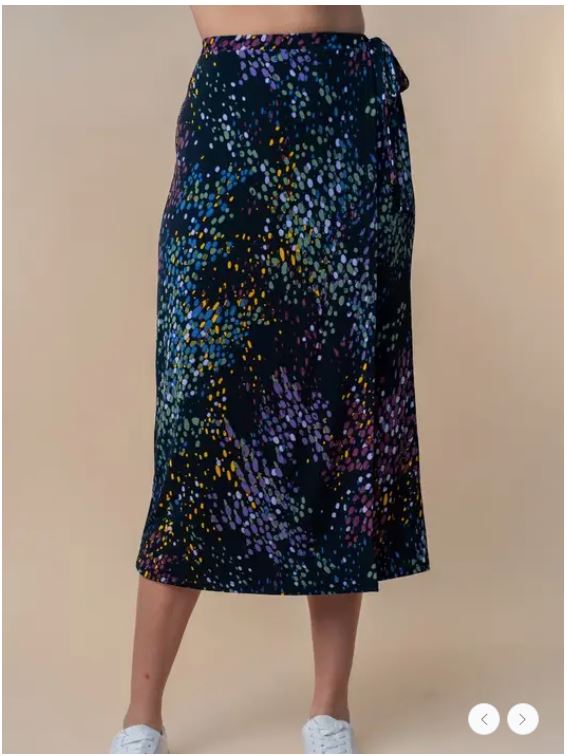Front view of plus size mock wrap midi skirt featuring a playful multicolor print, tie-waist detail, and flattering silhouette.