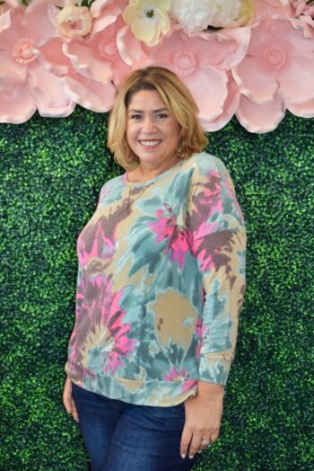Plus size model wearing Dear Scarlett Weekender Top in olive tie-dye print with pink and teal accents, relaxed fit front view.