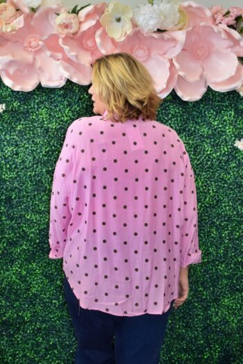 Back view of a plus-size pink polka dot oversized button-down blouse showcasing a breezy, lightweight design and relaxed everyday fit.