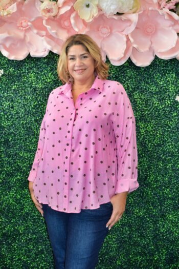 Front view of a plus-size pink polka dot oversized button-down blouse featuring a lightweight, flowy fit, relaxed silhouette, and chic casual style.