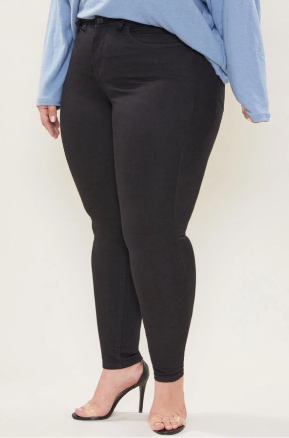 Front view of plus size woman wearing black hyperstretch denim jeans with 5-pocket styling, smoothing jegging fit, sizes 1x-3x.