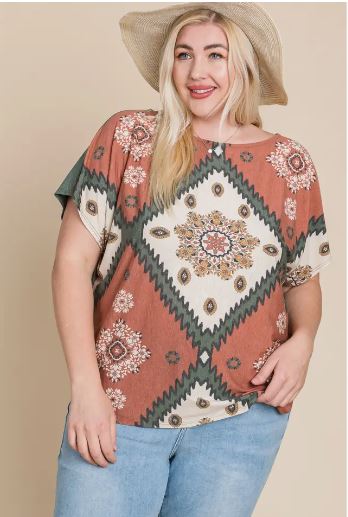 Front and back view of a plus-size floral chevron dolman sleeve top in rust, olive, and cream with a relaxed fit and off-shoulder style.