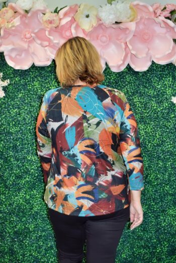 Back view of the Ballard Top showing the vibrant multicolor abstract pattern and flowy silhouette, designed to fit and flatter curvy women.