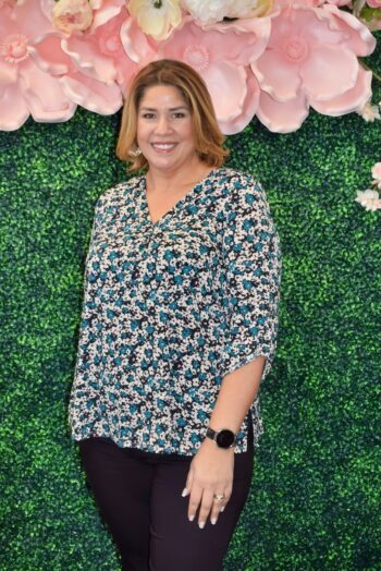 Front view of the Vera Top, a plus size floral print blouse featuring a flattering V-neckline, ¾ sleeves with split cuffs, and a relaxed fit perfect for work or weekend wear.