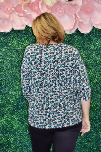 Back view of the Vera Top showing the flowy silhouette, floral print pattern, and comfortable ¾ sleeves, designed for a flattering fit on curvy women.