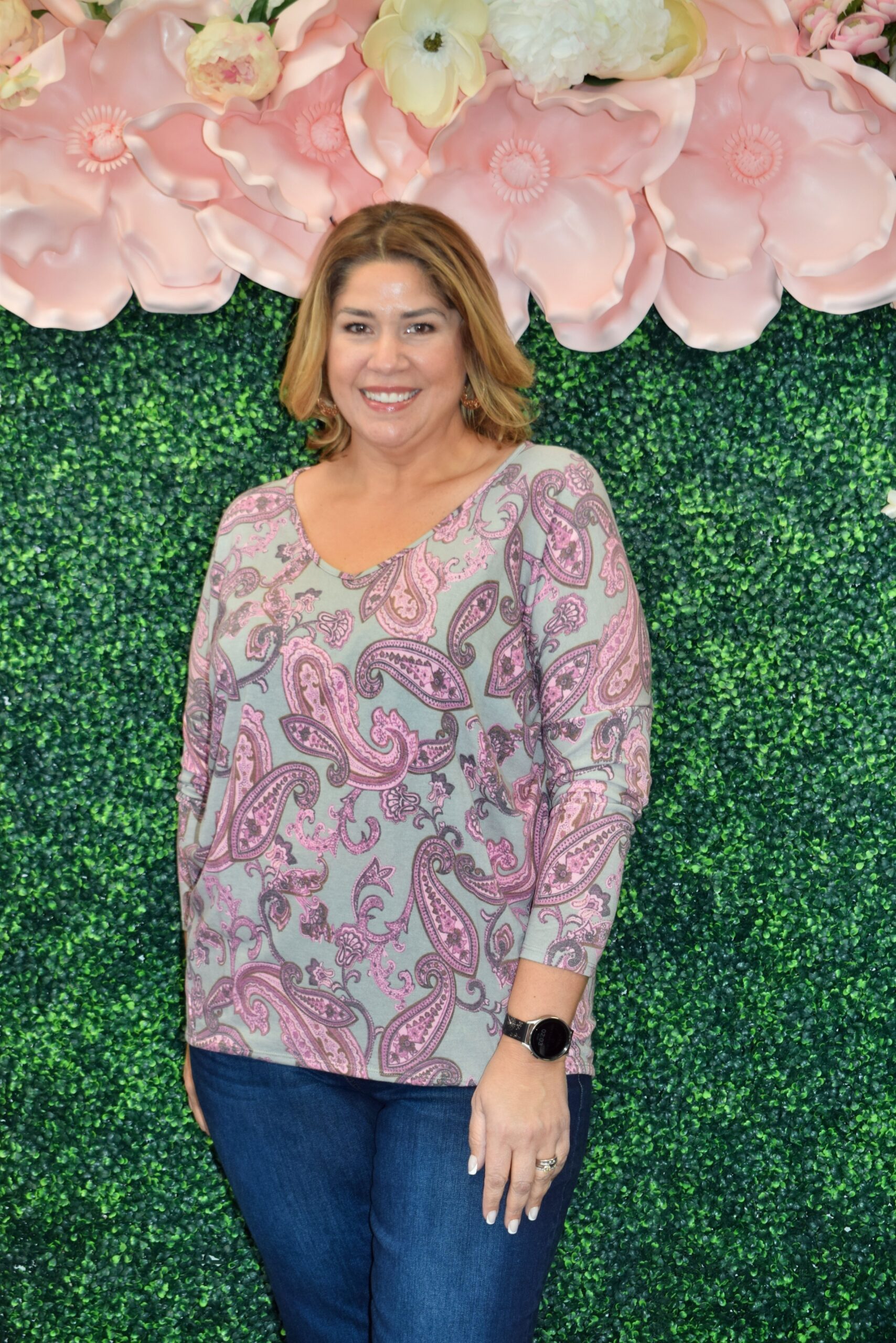 Front view of the Juliette Top, a plus size paisley print blouse in pink and gray tones featuring a double V-neckline, long sleeves, and a flattering relaxed fit.