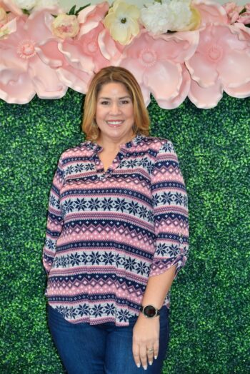 Front view of the Noelle Top by Dear Scarlett, a plus size Fair Isle print blouse in pink and navy featuring a split neckline, ¾ sleeves with tabs, and a flattering relaxed fit for curvy women.