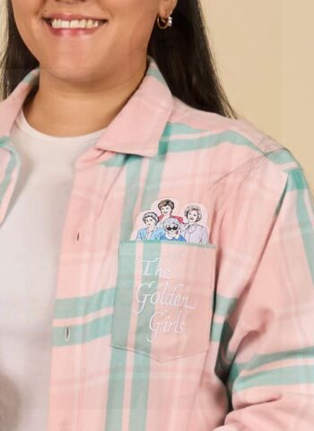 Close-up of The Golden Girls flannel shirt pocket featuring embroidered text and characters Dorothy, Rose, Blanche, and Sophia.