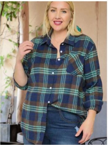 Front view of a plus-size woman wearing a blue and brown plaid button-up shirt with rolled sleeves, styled casually with jeans.