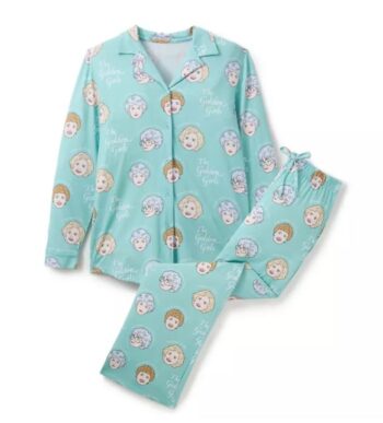 Golden Girls pajama set featuring Dorothy, Blanche, Rose, and Sophia on a teal cotton background, front view of two-piece set.