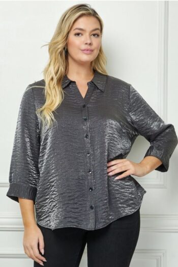 Plus-size model wearing the Shimmer Shirt in Charcoal Silver, a button-down metallic blouse with French cuffs, available in sizes S–3X at Botticelli Boutique.