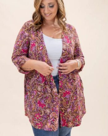 Plus-size woman wearing the Dear Scarlett Maribel Paisley Cardigan in magenta and bronze print, styled over a white tank and jeans.