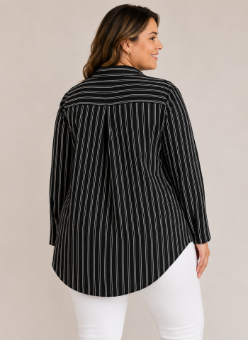 Woman wearing a silky striped button-down blouse styled for travel, work, and elevated everyday outfits.