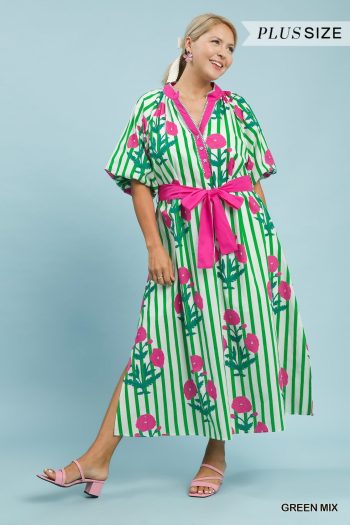 Plus-size model wearing a green and pink floral stripe midi dress with flutter sleeves and removable waist tie