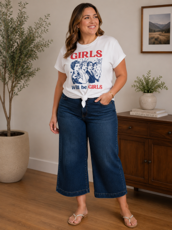 Patriotic graphic t-shirt with red, white, and blue vintage-inspired artwork styled with dark denim cropped jeans.