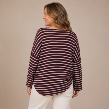 Back view of the Cabernet Stripe Sweater showing the relaxed silhouette, burgundy and ivory stripe pattern, drop shoulders, and curved hem.