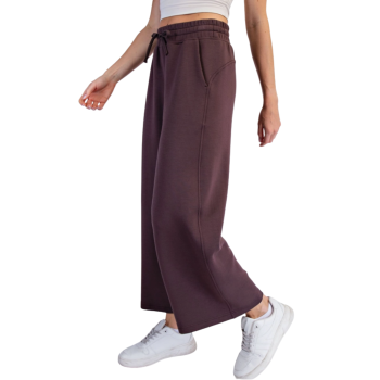 Side view of espresso Cropped Wide Leg Scuba Pants on a mid-size model featuring a high-rise elastic drawstring waistband, side pockets, wide-leg silhouette, and cropped ankle length.