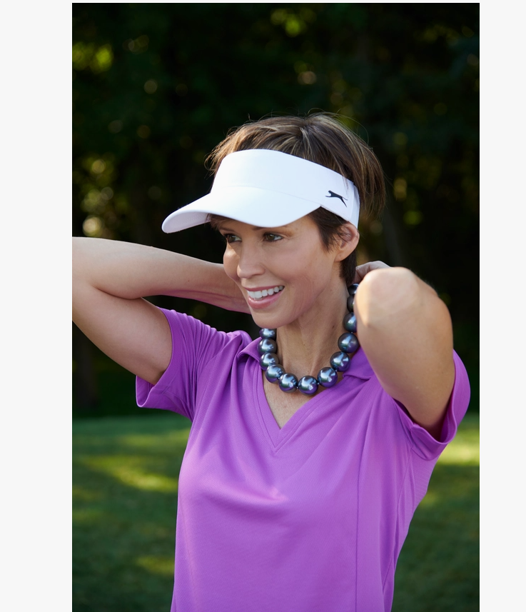 Woman wearing a gray Hot Girls Pearls cooling necklace while golfing, demonstrating fashionable cooling relief for outdoor activities.